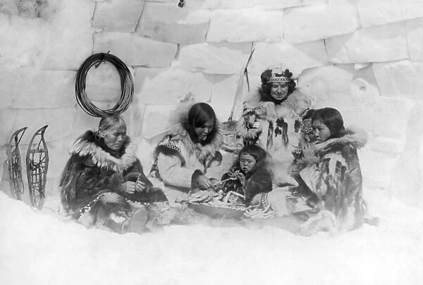 ALASKA: ESKIMO DINNER. An Eskimo family and the photographers wife eating a dinner