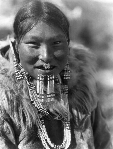 ALASKA: ESKIMO WOMAN. Eskimo woman from Nunivak Island wearing necklaces, earrings