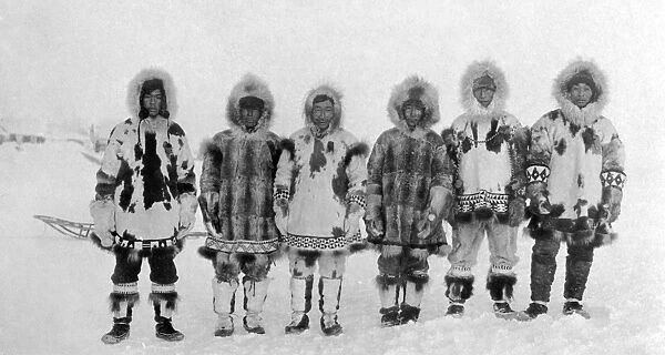 ALASKA: ESKIMOS. A group of six Eskimo men posing in the snow in traditional fur clothing, Alaska