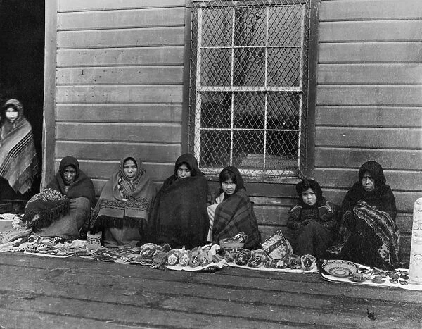 ALASKA: TLINGIT WOMEN, 1905. Tlingit women and girls displaying handcrafted items