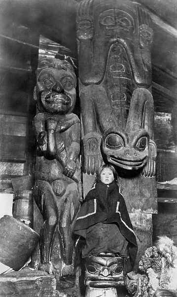 ALASKA: TOTEM POLES, c1895. Three old totem poles inside the house of a chief