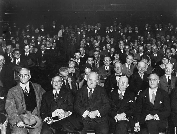 ALFRED EMANUEL SMITH. Presidential campaign of 1928: Alfred E. Smith, seated second row center, listens to election results at the 71st Regiment. Seated in the first row from left to right are: John J. Glynn, Senator Robert Wagner, James P. O Brien, George R. Van Namie and governor-elect F. D. Roosevelt