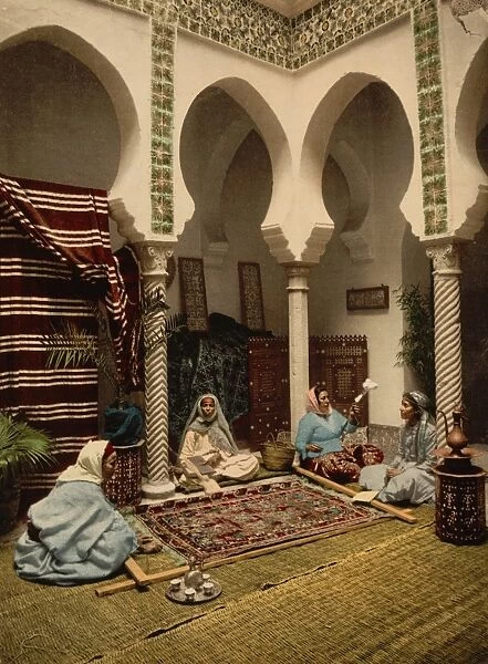 ALGIERS: CARPET-MAKERS. Women carding wool, spinning yarn and weaving carpets in