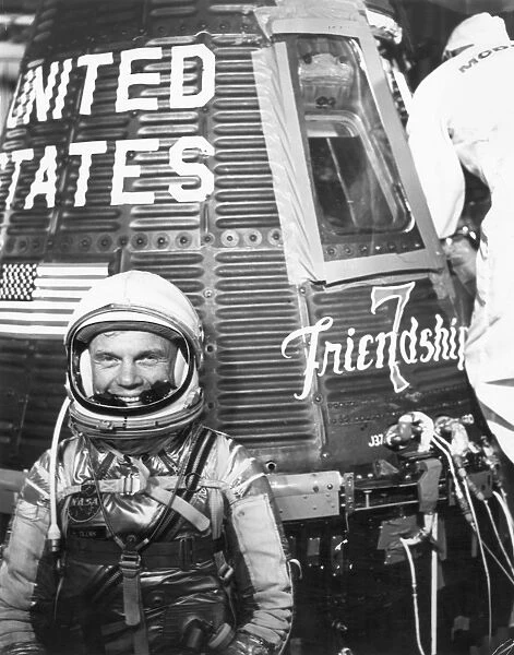 American astronaut and politician. Pictured with the Friendship 7 space capsule shortly before Glenn became the first American to orbit the Earth, Feb. 20, 1962