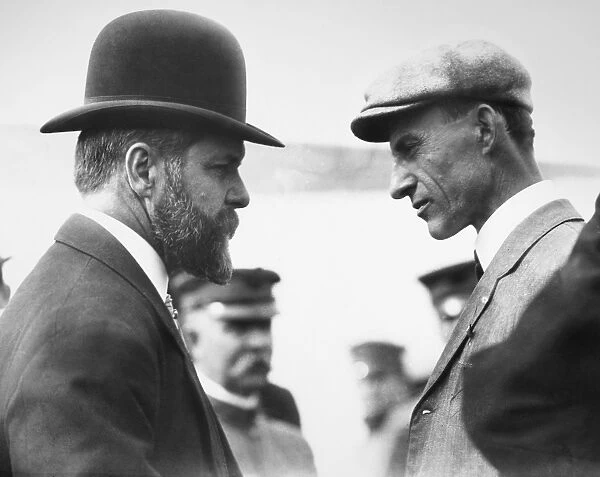 American aviation pioneer. Talking to an unidentified person after his successful exhibition flight of 4 October 1909