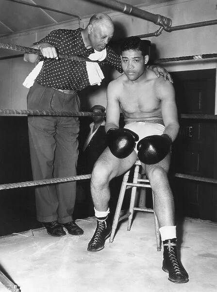 American heavyweight pugilist. In training camp at Pompton Lakes, New York, 4 June 1938, with his trainer Jack Blackburn