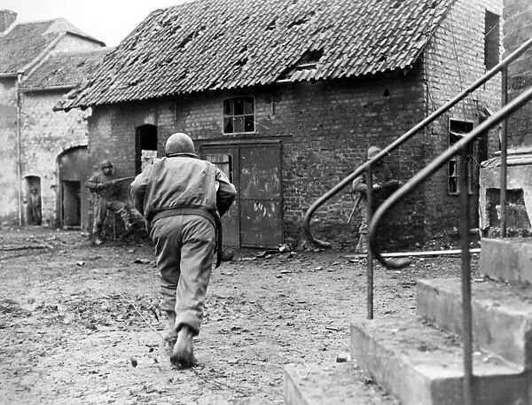 American soldiers of Company F, 83rd Infantry Division, engaged in house-to-house fighting in the suburbs of Duren, Germany, 1945