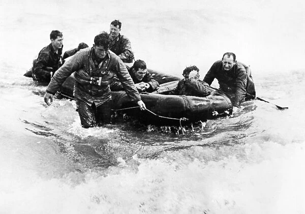 American soldiers land on the beach at Normandy by life raft after their landing craft had been sunk by German shelling, 6 June 1944
