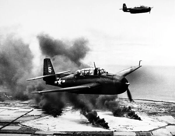 American TBF Avenger torpedo bombers attack a Japanese airstrip on Tinian Island, part of the Mariana Islands, 10 March 1944