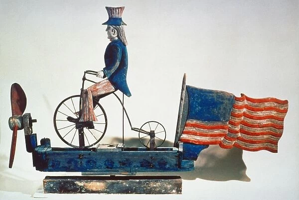 American whirligig of Uncle Sam on bicycle. Wood and metal, c1876