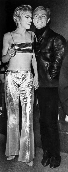 ANDY WARHOL (1928-1987). American artist and filmmaker. Photographed in 1965 with one of his stars, actress and model Edie Sedgwick