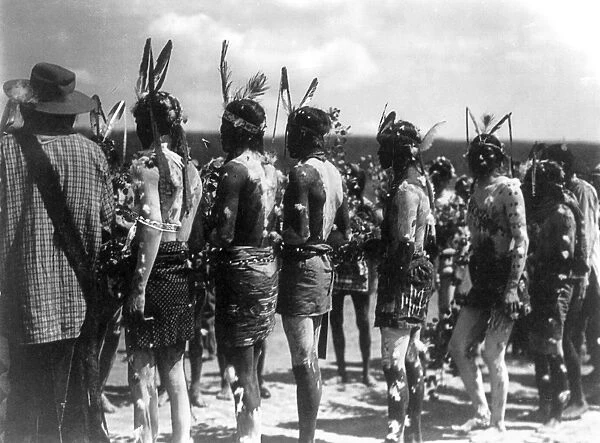 APACHE CEREMONY, c1905. Group of Apache men wearing feathered headbands and body