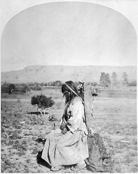 APACHE WOMAN, 1873. An Apache woman with a baby in a cradleboard