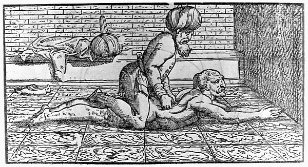 Arabic physician and philosopher. Avicenna massaging a patient. Woodcut from Avicennae Arabum Medicorum Principis, published in Venice, 1595