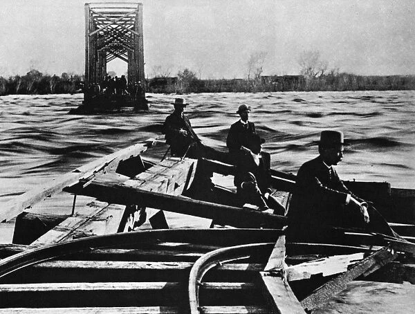 ARIZONA: FLOOD, 1891. Men seated on the wreckage of a railroad bridge on the Salt