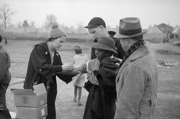 ARKANSAS: INOCULATION, 1937. A refugee being given an inoculation for typhoid at