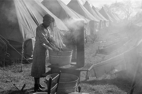 ARKANSAS: REFUGEES, 1937. A flood refugee washing clothes in the refugee camp at Forrest City