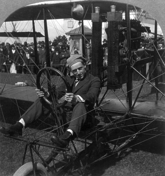 ART SMITH (1894-1926). American aviator, stunt pilot and pioneer of skywriting at night. Photographed seated in the cockpit of his biplane on the aviation field at the Panama-Pacific International Exposition, San Francisco, California. Stereograph, 24 June 1915