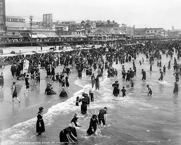 ATLANTIC CITY: BEACH. A view of the shoreline with crowds of people bathing in the water, Atlantic City, New Jersey. Photograph, c1902