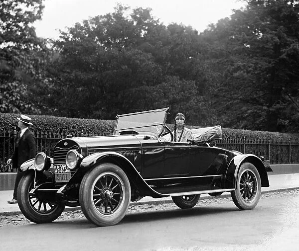AUTOMOBILE, 1923. A woman wearing Native American clothing, in a car in the Washington, D
