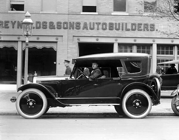 AUTOMOBILE, c1922. An automobile outside of the American company Reynolds & Sons Autobuilders