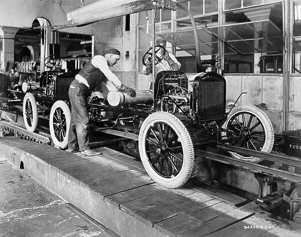 AUTOMOBILE FACTORY, c1923. Assembly line workers at an American automobile factory