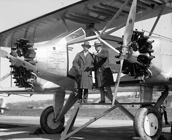 AVIATORS, 1927. American aviators Noel Davis and Stanton H. Wooster standing near an airplane