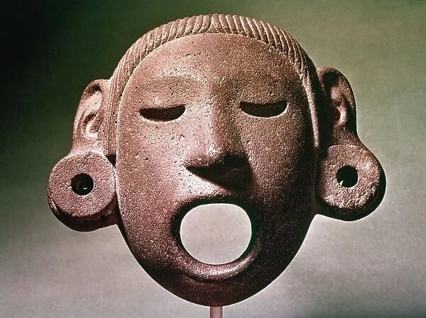 AZTEC MASK: XIPE TOTEC. Stone mask of Xipe Totec, god of life-death-rebirth, agriculture, the west, disease, spring, goldsmiths and the seasons. Aztec period, Mexico