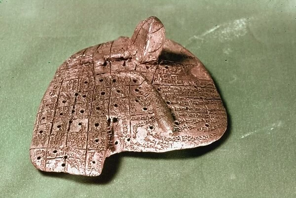 BABYLONIAN CUNEIFORM. Babylonian clay model of a sheeps liver inscribed with omens for diviners