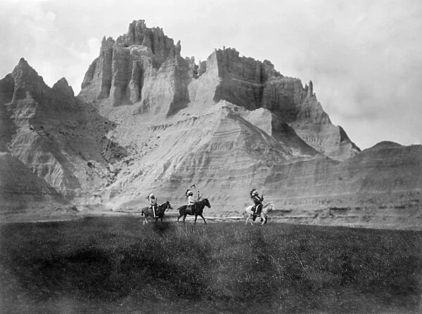 BADLANDS, c1905. Three Sioux Indians on horseback in the Badlands, South Dakota