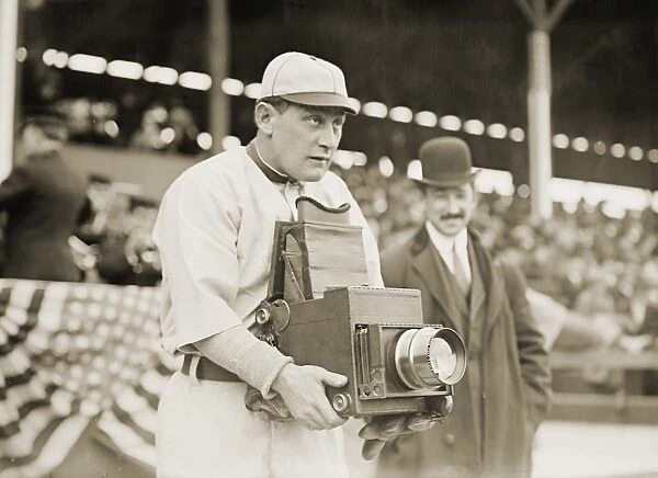 BASEBALL: CAMERA, c1911. Herman A. Germany Schaefer, baseball player for the Washington Senators, using a camera, New York. Photograph, c1911