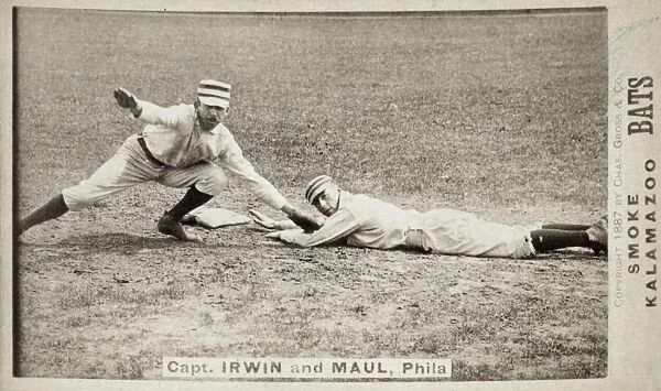BASEBALL GAME, c1887. Arthur Albert Irwin (left) tags out Albert Joseph Maul on a baseball card while both were playing with the Philadelphia Quakers  /  Phillies, c1887