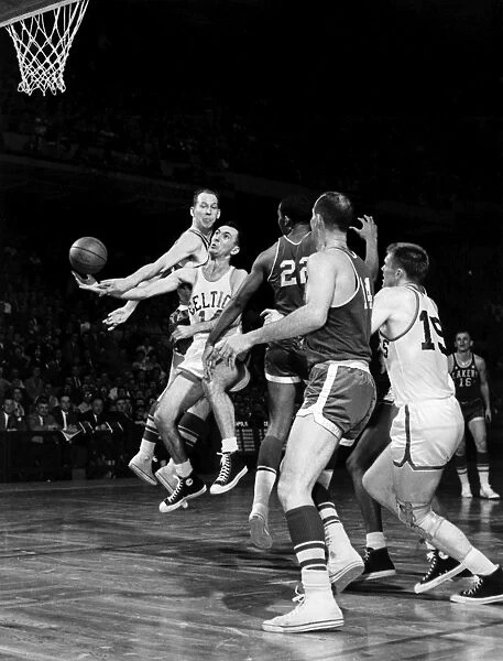 BASKETBALL GAME, c1960. Bob Cousy of the Boston Celtics (number 14) jumps for the ball during a game against the Los Angeles Lakers, c1960