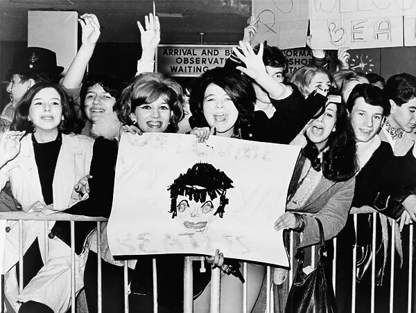 THE BEATLES, 1964. Screaming fans greeting the Beatles upon their arrival at John F