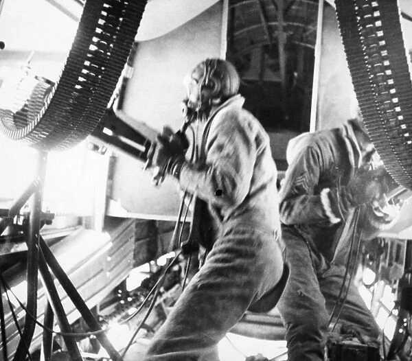 Two belly gunners in a B-24 firing at attacking 109 Messerschmidts over Italy, 1943