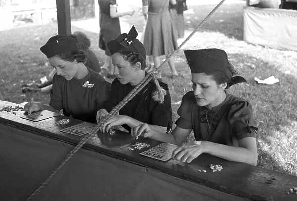BINGO GAME, 1938. Three women playing bingo at the Louisiana State Fair in Donaldsonville