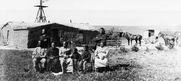 BLACK HOMESTEADERS. The Moses Speese family outside their sod house near Westville, Nebraska