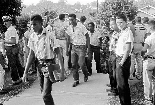 Black students walking through a crowd of white boys in Clinton, Tennessee, during a period of violence related to school integration, 4 December 1956. Photographed by Thomas J. O Halloran