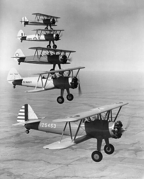Boeing military trainer airplanes bound for five different services (from top to bottom): Peru, Great Britain, China, U. S. Navy and U. S. Air Corps. Photographed during a demonstration, 1942
