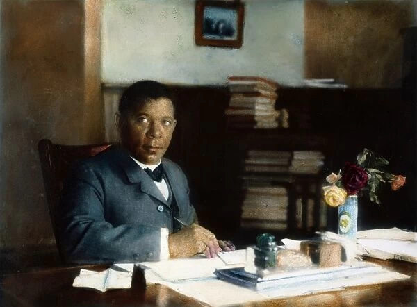 BOOKER T. WASHINGTON (1856-1915). American educator in his office at Tuskegee Institute, Alabama