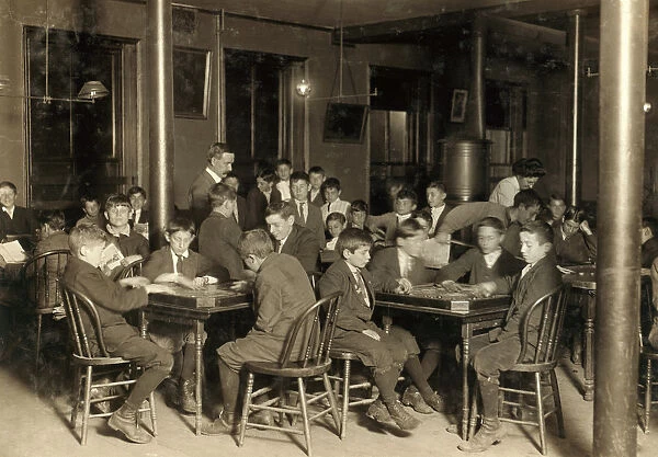 BOSTON: NEWSBOYS, 1909. Boys seated at tables playing games in the Newsboys Reading Room