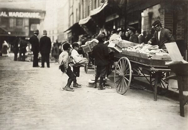 BOSTON: THIEVES, 1909. Two boys stealing from a pushcart vendor, Boston, Massachusetts