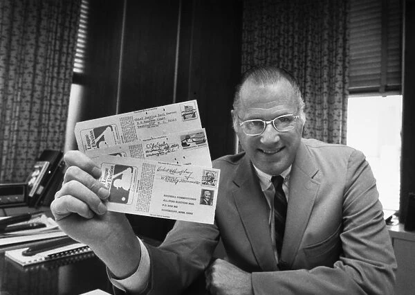 BOWIE KUHN (1926-2007). American lawyer and baseball commissioner. Photographed in his office, c1970, holding mail-in ballots for major league baseballs All-Star Game submitted by former Chief Justice Earl Warren, Senator Eugene McCarthy of Minnesota, and former Vice President Hubert Humphrey
