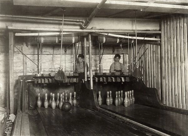 BOWLING ALLEY, 1910. Pin boys working at a bowling alley until midnight in Syracuse, New York