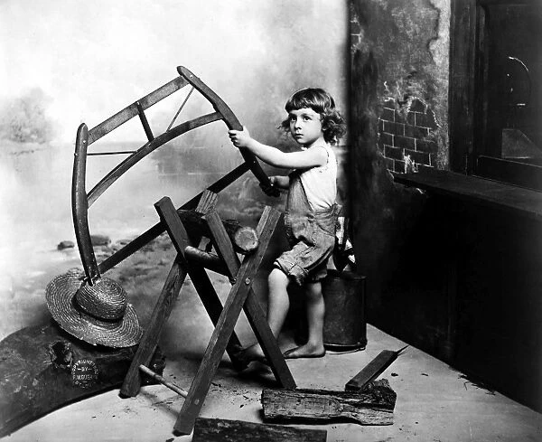 BOY SAWING, 1902. Photographed by Fritz W. Guerin, St. Louis, 1902