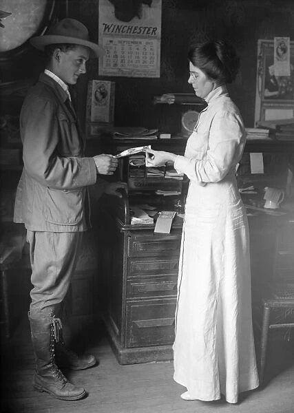 BOY SCOUT, 1913. Making a deposit at a postal savings location, United States