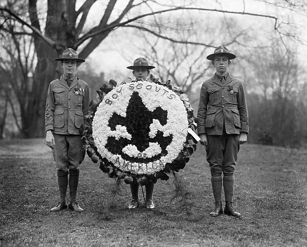 BOY SCOUTS, 1924. A group of Boy Scouts with a decorative wreath. Photograph, 1924