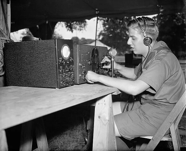 BOY SCOUTS: RADIO, 1937. Larry Le Kashman operating a short-wave radio that will