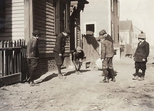 BOYS SHOOTING CRAPS, 1912. Group of boys playing with dice in the dirt, Providence, Rhode Island