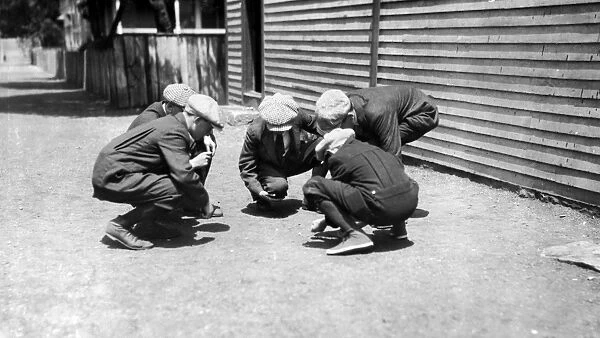 BOYS SHOOTING CRAPS, c1916. Group of textile mill boys on Sunday, gambling with
